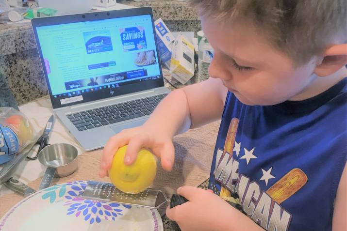 Boy grating a lemon